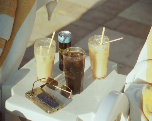 notebook, coffee and a phone on a sunny afternoon table